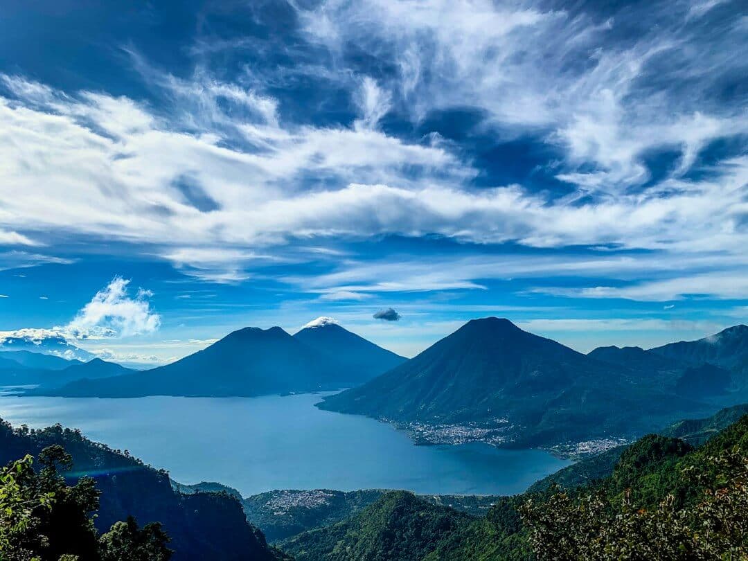 green mountains under white clouds and blue sky during daytime